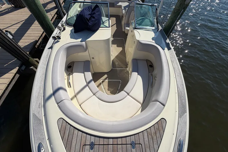 Slide: The Image of 2019 Chris-Craft Launch 30 boat with elegant seating, docked by the water. - 10