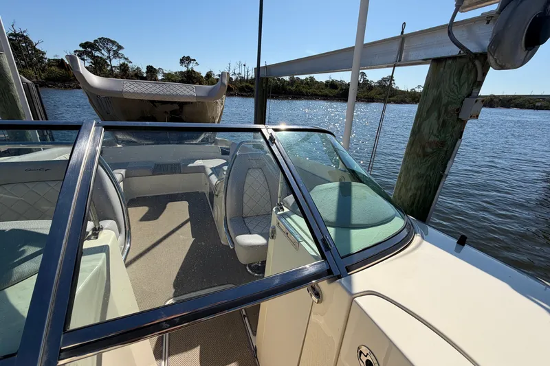 Slide: The Image of 2019 Chris-Craft Launch 30 boat docked by a serene waterfront. - 13