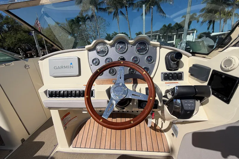 Slide: The Image of 2019 Chris-Craft Launch 30 dashboard with Garmin navigation and wooden steering wheel. - 17