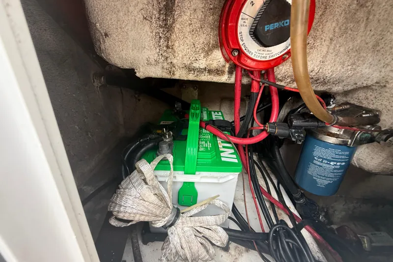 Slide: The Image of Battery compartment of a 2005 Sea Hunt Triton 232 boat, featuring a Duracell marine battery. - 11