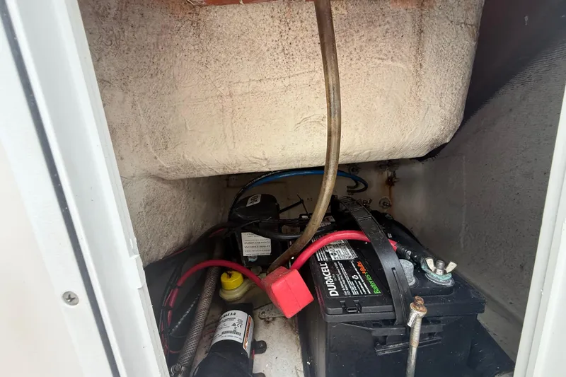 Slide: The Image of 2005 Sea Hunt Triton 232 boat near modern house with gray exterior. - 13