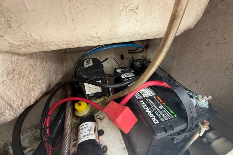 Slide: The Image of 2005 Sea Hunt Triton 232 boat dashboard with Garmin navigation system and steering wheel. - 14