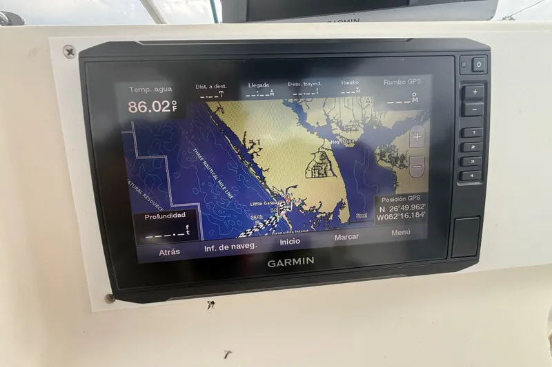 Slide: The Image of Open storage compartment on a 2005 Sea Hunt Triton 232 boat, showing electronic equipment and wiring. - 22
