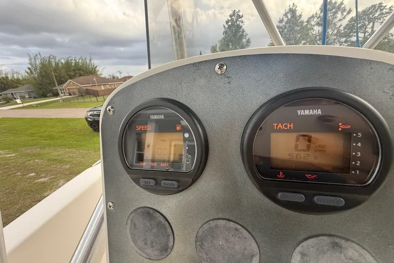 Slide: The Image of VHF marine radio on 2005 Sea Hunt Triton 232 boat, featuring distress button and coiled microphone. - 23