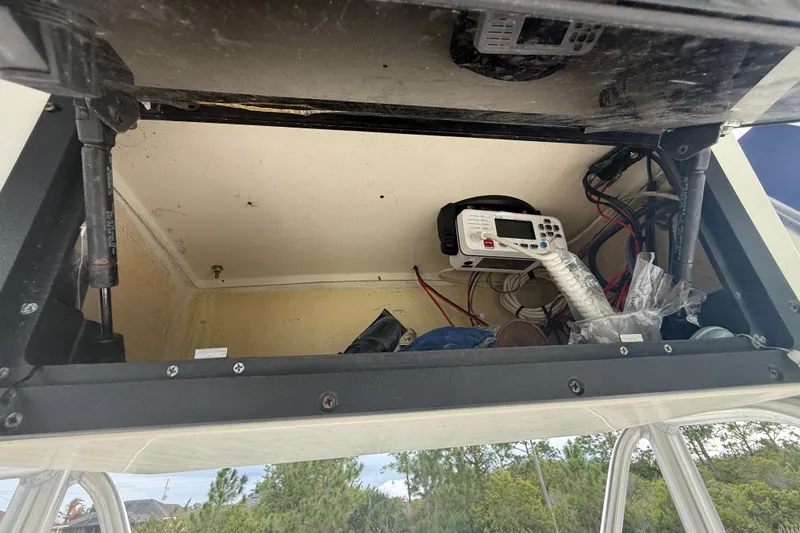 Slide: The Image of Storage compartment in a 2005 Sea Hunt Triton 232 boat with safety equipment. - 24