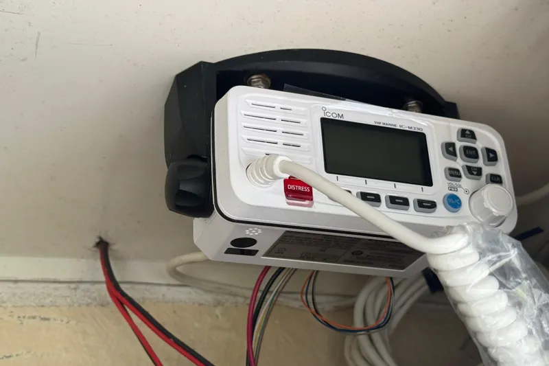 Slide: The Image of 2005 Sea Hunt Triton 232 boat with T-top and Garmin navigation system, parked on grass. - 25