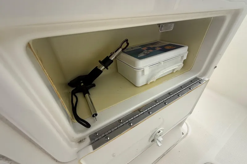 Slide: The Image of 2005 Sea Hunt Triton 232 boat with fishing rod holders and Garmin equipment under cloudy skies. - 26