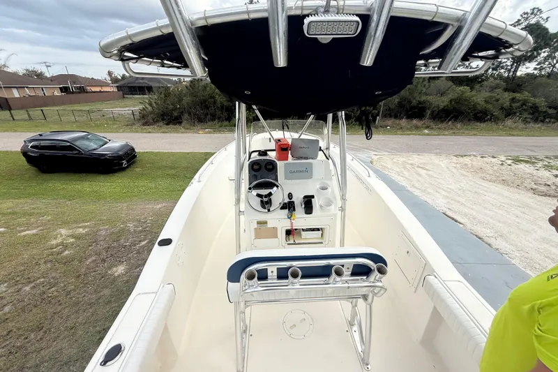 Slide: The Image of 2005 Sea Hunt Triton 232 boat with rod holders and light against cloudy sky. - 27