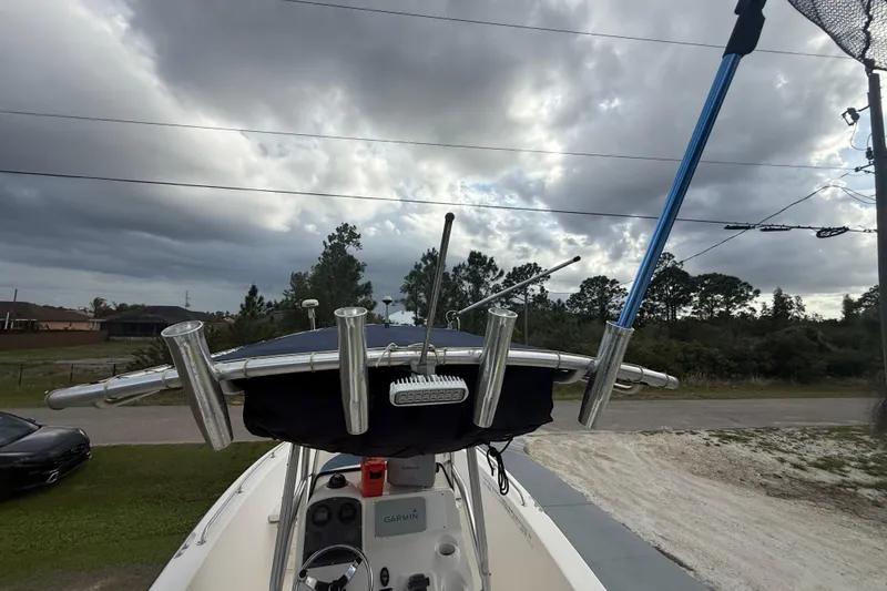 Slide: The Image of 2005 Sea Hunt Triton 232 boat canopy and frame under cloudy sky. - 28