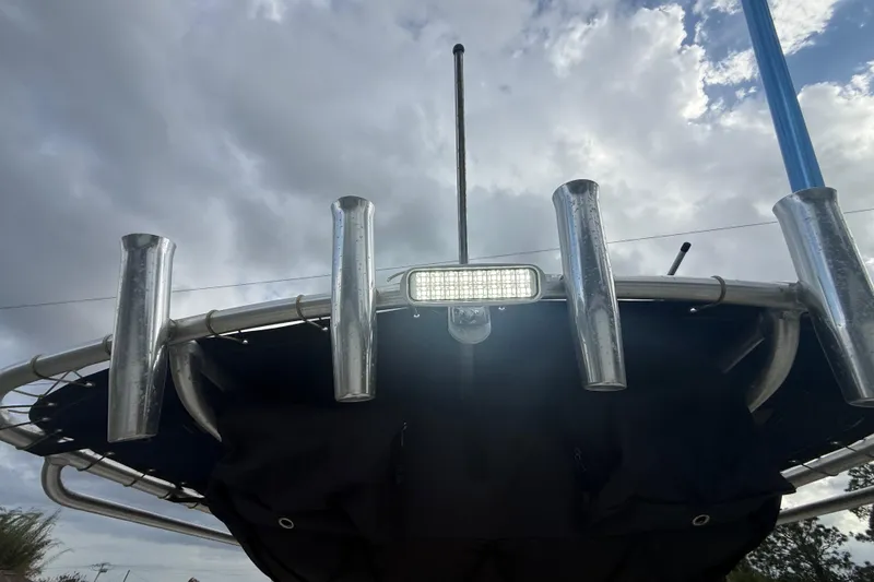 Slide: The Image of 2005 Sea Hunt Triton 232 boat canopy with mounted LED light under cloudy sky. - 29