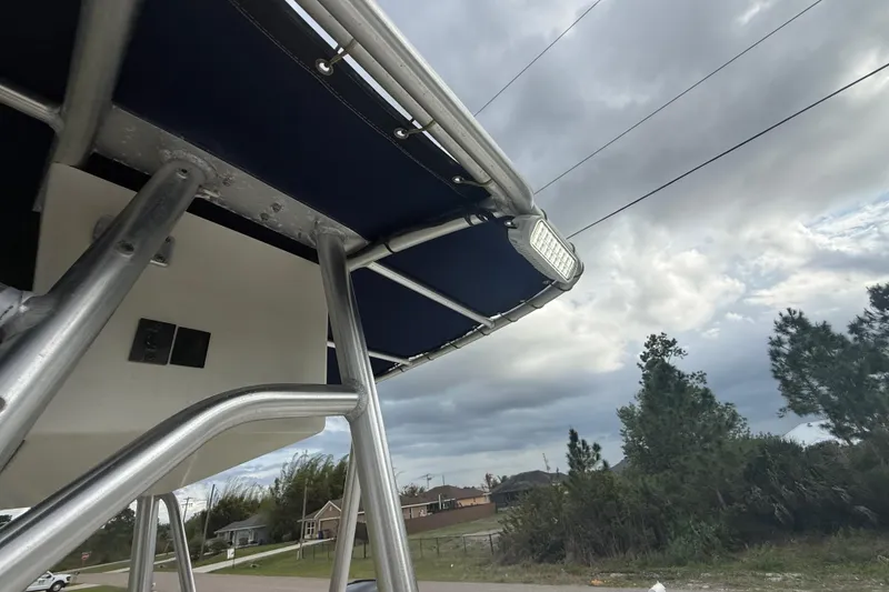 Slide: The Image of Fishing net on Sea Hunt Triton 232 boat, 2005 model, against cloudy sky backdrop. - 30