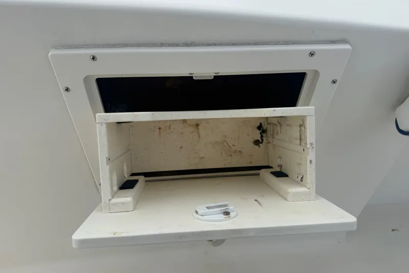 Slide: The Image of 2005 Sea Hunt Triton 232 boat with Yamaha 250 engine, parked near a garage. - 33