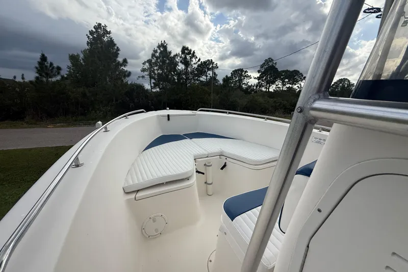 Slide: The Image of 2005 Sea Hunt Triton 232 boat interior with white cushioned seating. - 37