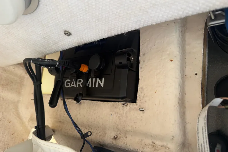 Slide: The Image of 2005 Sea Hunt Triton 232 boat interior with white and blue cushioned seating. - 44