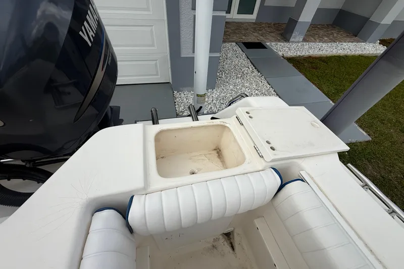 Slide: The Image of 2005 Sea Hunt Triton 232 boat interior with white and blue seating. - 7