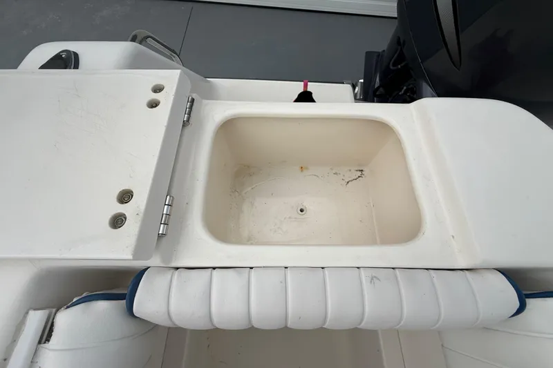 Slide: The Image of Open storage compartment on 2005 Sea Hunt Triton 232 boat, showing interior details. - 8