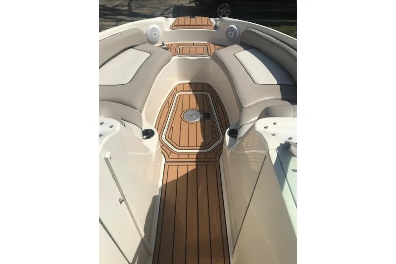 Slide: The Image of 2003 Sea Ray 240 Sundeck interior with teak flooring and cushioned seating. - 7