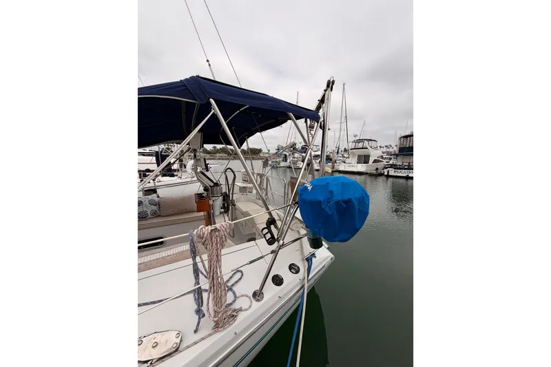 Slide: The Image of Sailboat Catalina 36 MkII, 1996 model, docked with blue cover and ropes. - 12