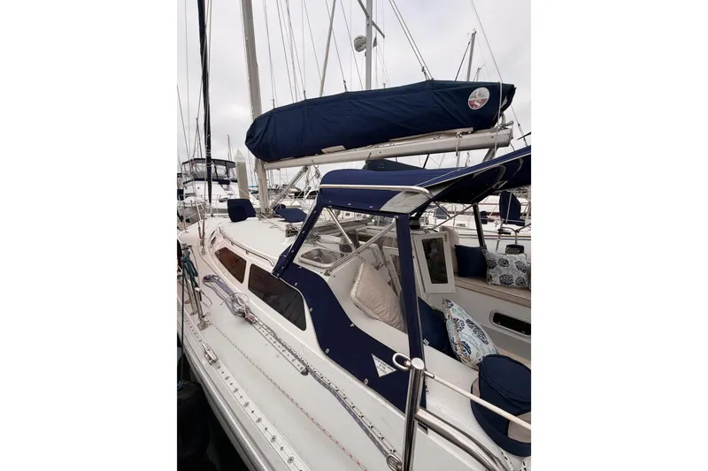 Slide: The Image of Sailboat Catalina 36 MkII 1996 with blue covers docked at marina. - 13