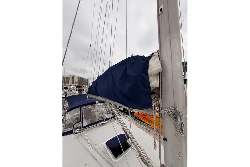 Slide: The Image of 1996 Catalina 36 MkII sailboat with blue sail cover at marina. - 19