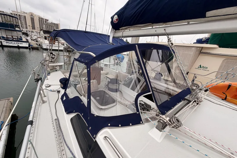 Slide: The Image of 1996 Catalina 36 MkII sailboat docked, featuring blue canvas covers and marina backdrop. - 20