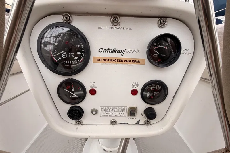 Slide: The Image of Control panel of a 1996 Catalina 36 MkII yacht with gauges and warning labels. - 26