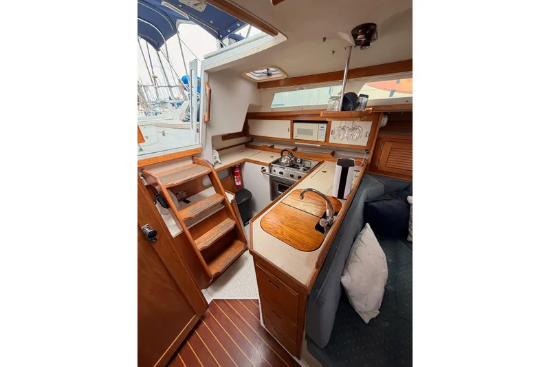 Slide: The Image of Interior of 1996 Catalina 36 MkII sailboat with wooden cabinetry and compact kitchen area. - 35