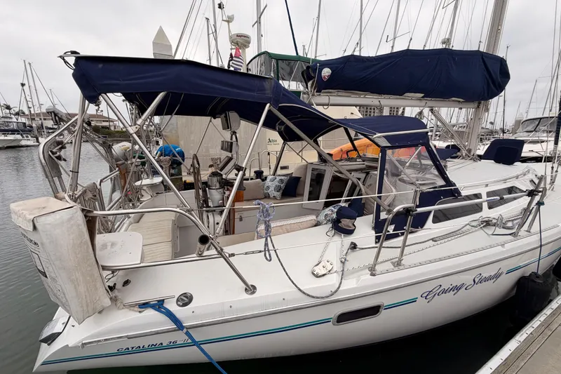 Slide: The Image of 1996 Catalina 36 MkII sailboat docked in marina, featuring blue canvas covers. - 4