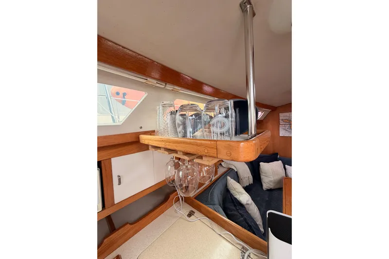 Slide: The Image of Interior of 1996 Catalina 36 MkII sailboat with glassware and cozy seating area. - 42