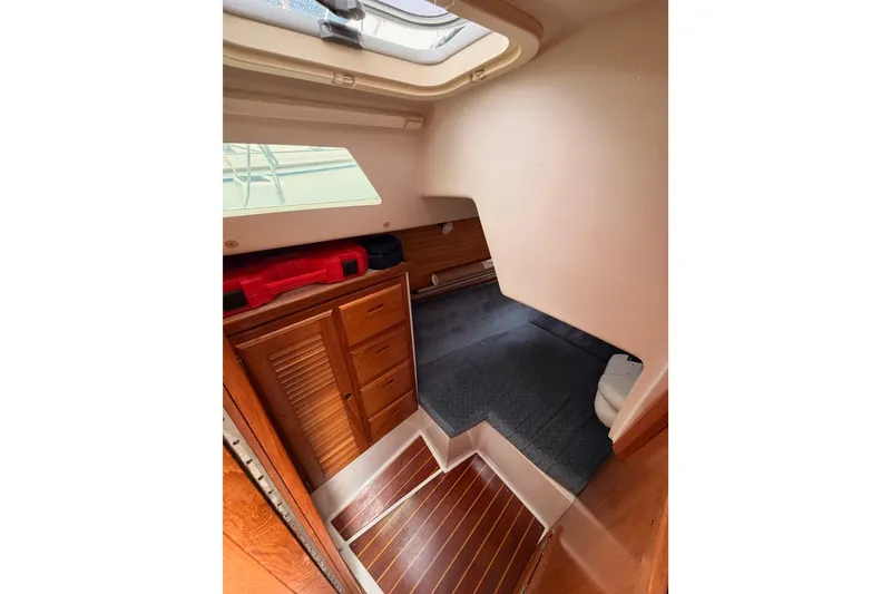 Slide: The Image of Interior cabin of 1996 Catalina 36 MkII sailboat with wooden cabinetry and carpeted flooring. - 44
