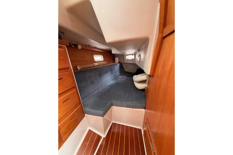Slide: The Image of Interior cabin of a 1996 Catalina 36 MkII sailboat with wooden cabinetry and cushioned seating. - 45