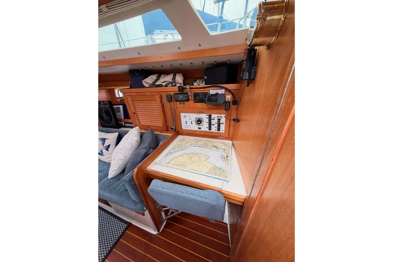 Slide: The Image of Navigation station inside a 1996 Catalina 36 MkII sailboat, featuring a chart table and control panel. - 47
