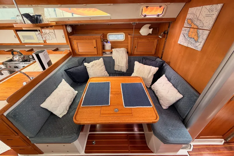 Slide: The Image of Cozy interior of 1996 Catalina 36 MkII sailboat with cushioned seating and wooden table. - 51