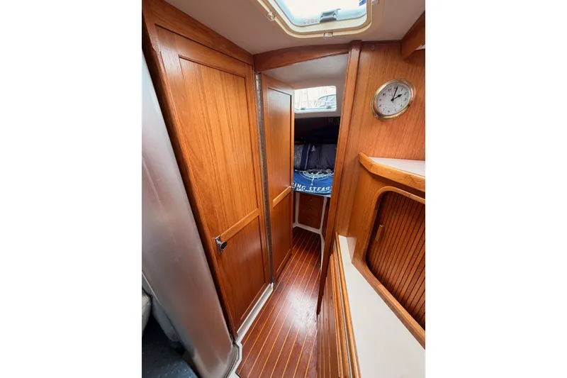 Slide: The Image of Interior of 1996 Catalina 36 MkII sailboat with wooden cabinetry and clock. - 55