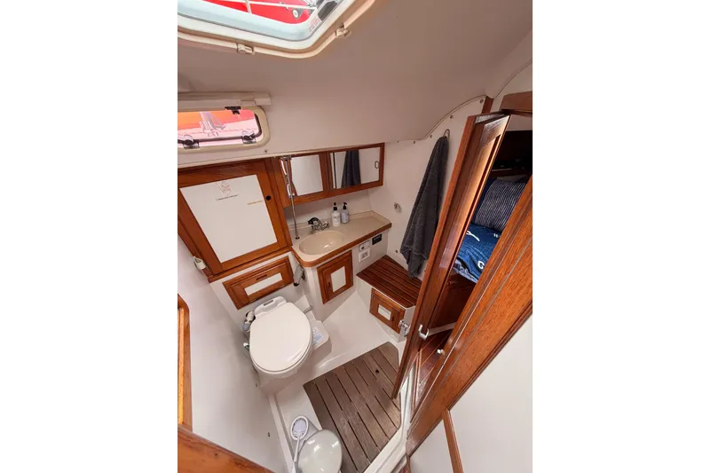 Slide: The Image of Interior of 1996 Catalina 36 MkII sailboat bathroom with wooden accents and compact design. - 56