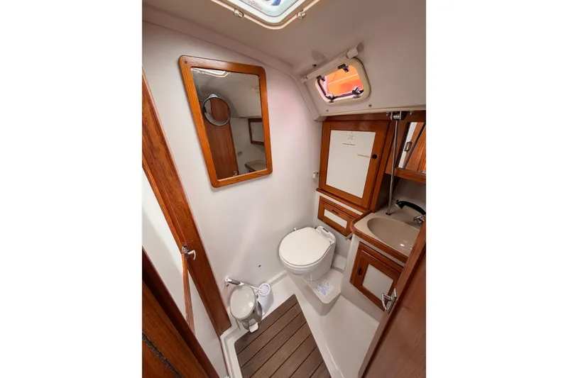 Slide: The Image of Bathroom interior of 1996 Catalina 36 MkII sailboat with wooden accents and compact design. - 60