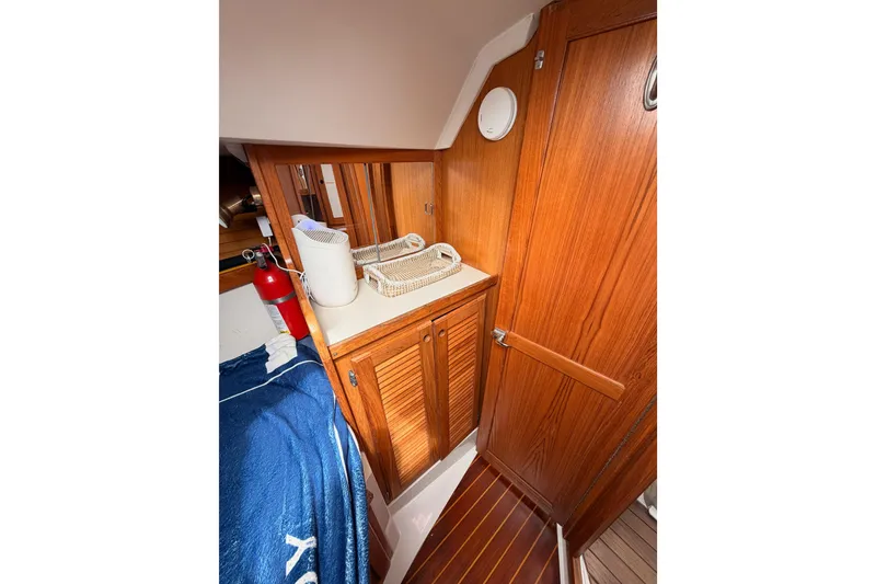 Slide: The Image of Interior of 1996 Catalina 36 MkII sailboat with wooden cabinetry and fire extinguisher. - 61