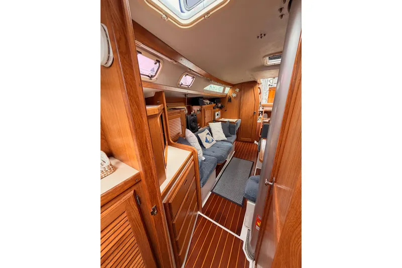 Slide: The Image of Interior of a 1996 Catalina 36 MkII sailboat with cozy seating and wooden finishes. - 62