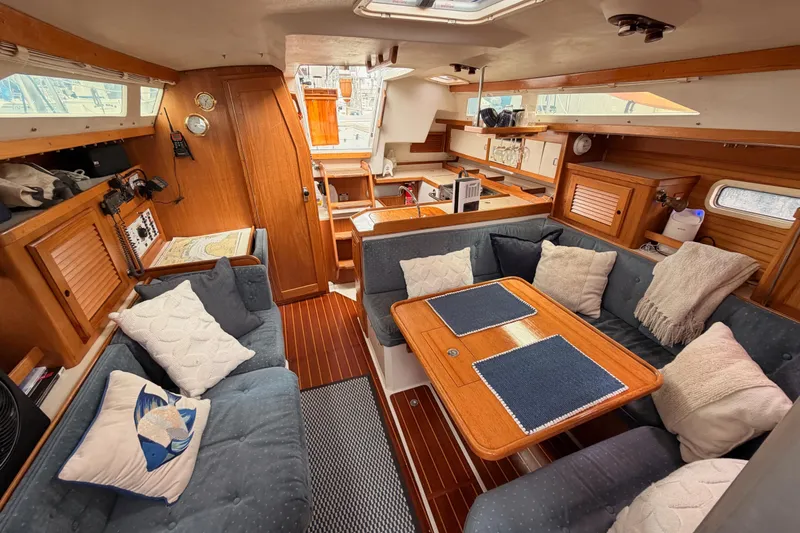 Slide: The Image of Interior of a 1996 Catalina 36 MkII sailboat with cozy seating and wooden finishes. - 64