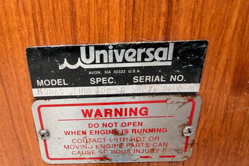 Slide: The Image of Universal engine label on 1996 Catalina 36 MkII with warning sign. - 70