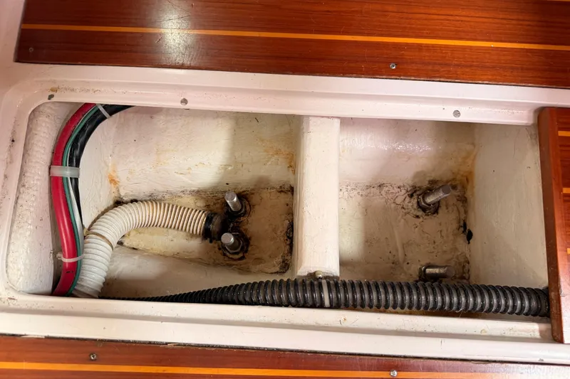 Slide: The Image of Bilge compartment of 1996 Catalina 36 MkII sailboat with visible hoses and wiring. - 71