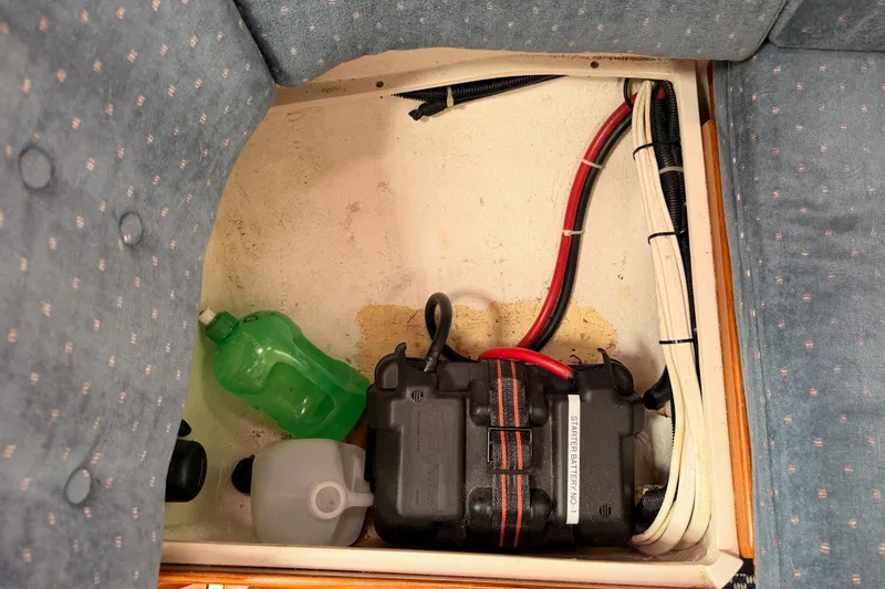Slide: The Image of Battery compartment in a 1996 Catalina 36 MkII sailboat with wiring and containers. - 72
