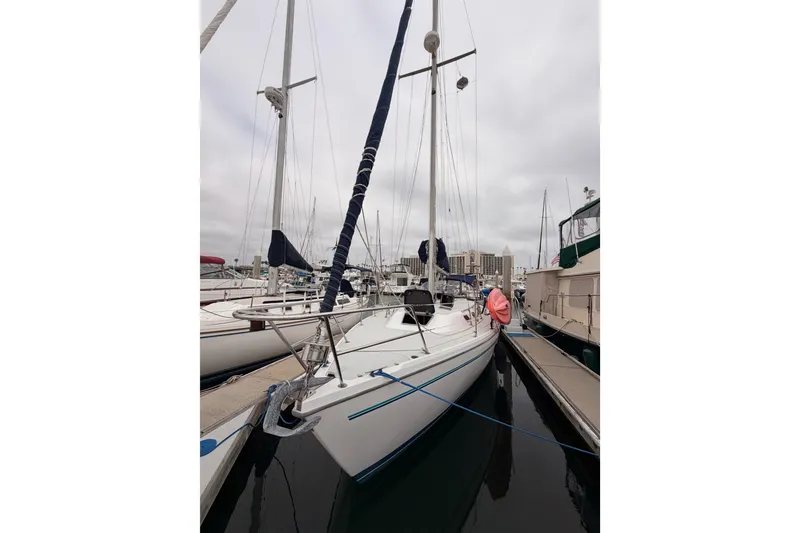 Slide: The Image of 1996 Catalina 36 MkII sailboat docked at marina under cloudy sky. - 9