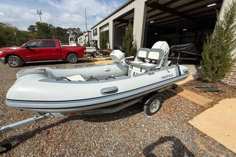 The Image of 2026 Highfield Classic 360 FCT inflatable boat on trailer, parked outdoors. - 1