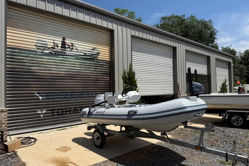 Slide: The Image of Highfield Classic 360 FCT 2026 boat on trailer outside storage facility. - 10