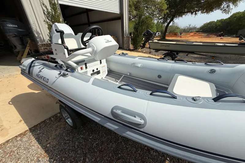 Slide: The Image of 2026 Highfield Classic 360 FCT inflatable boat parked outdoors, showcasing sleek design and seating. - 2