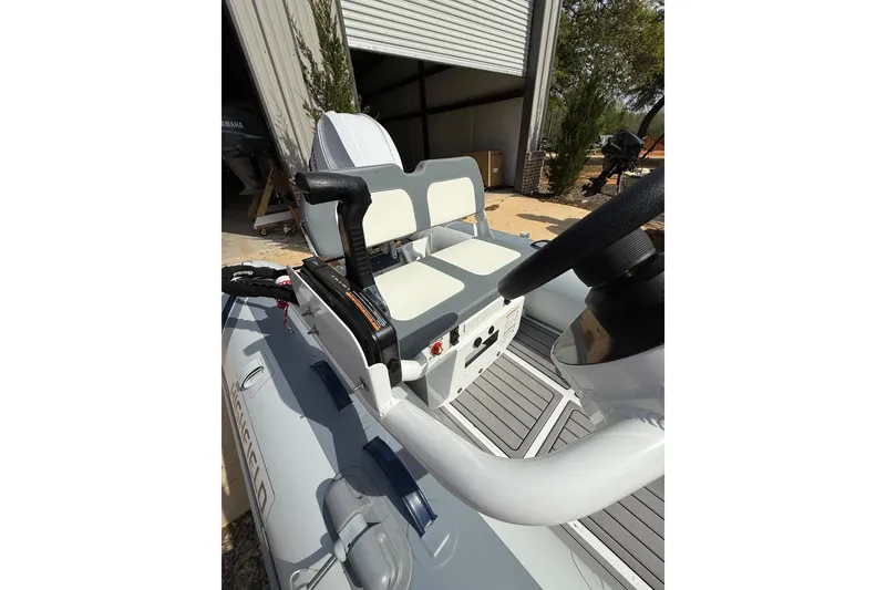 Slide: The Image of 2026 Highfield Classic 360 FCT boat interior with steering wheel and seating. - 5