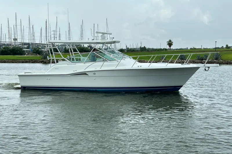Slide: The Image of 1996 Hatteras 39 Sport Express boat cruising on a calm waterway. - 12