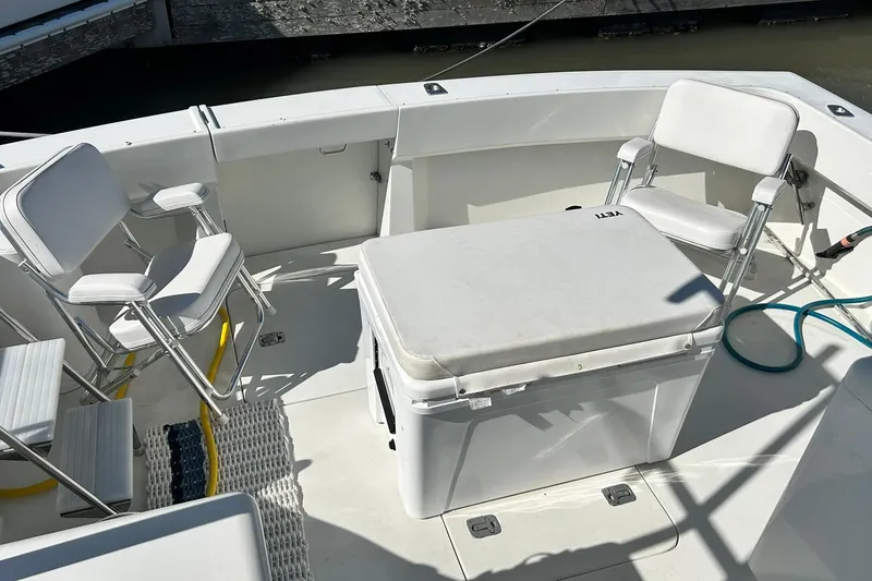 Slide: The Image of 1996 Hatteras 39 Sport Express boat deck with seating and cooler. - 15