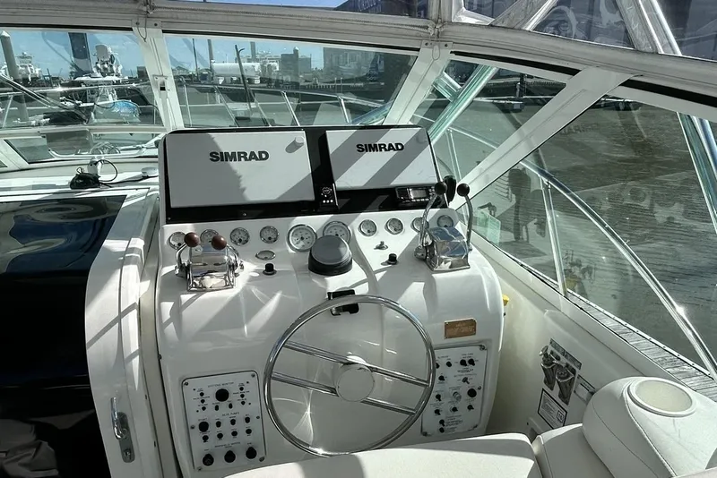 Slide: The Image of Helm of 1996 Hatteras 39 Sport Express with Simrad navigation system and dual controls. - 16